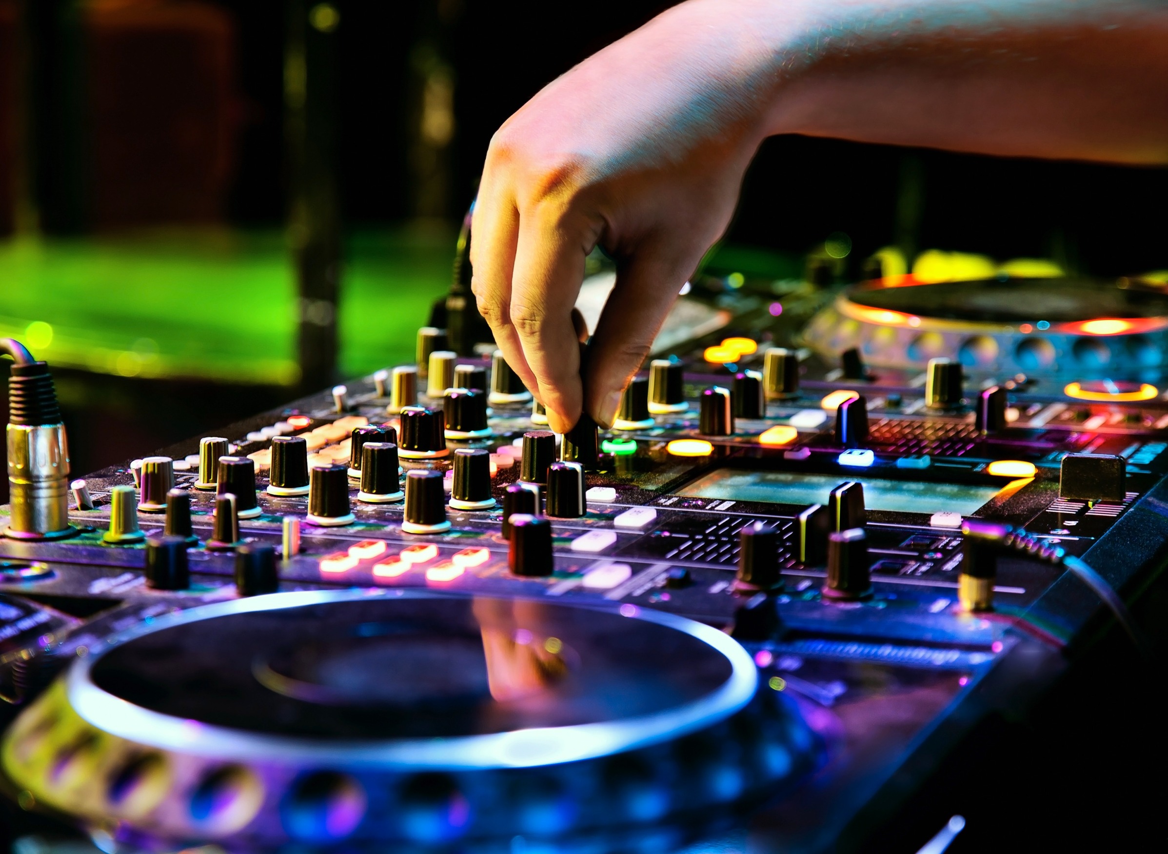 dj mixes the track in the nightclub at a party